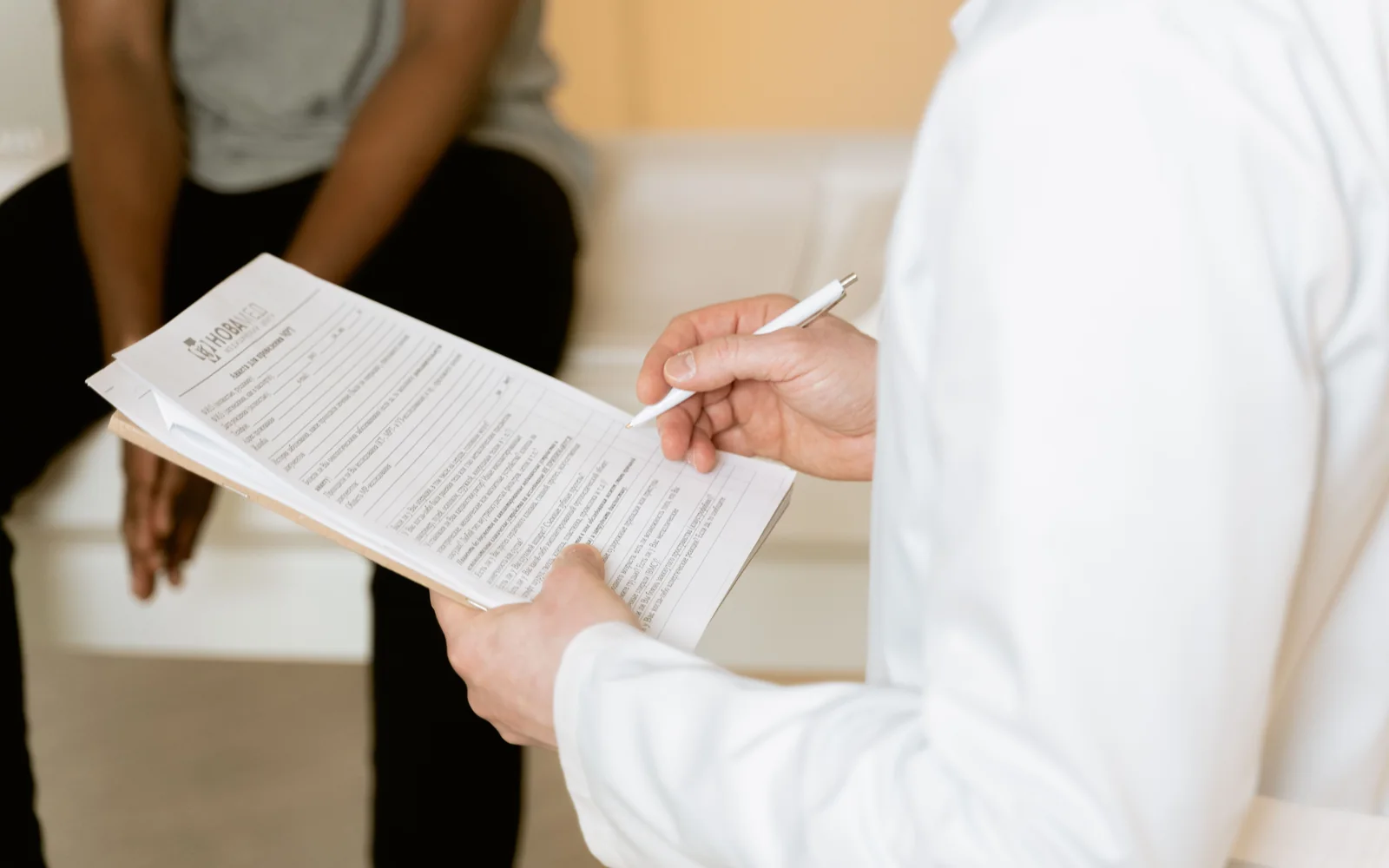A healthcare professional reviewing a form during a consultation